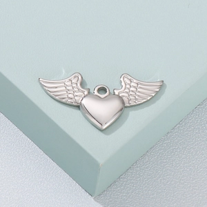 Macro shot of silver stainless steel angel wing heart pendant on a display stand
