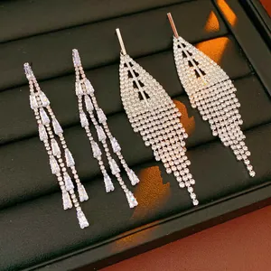 Elegant silver triangle earrings with sparkling tassels in a black luxury display box