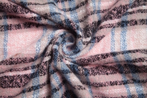 Macro detail of soft pink and blue plaid fabric texture with twill weaving on scarf