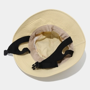 Detail of breathable mesh lining and adjustable chin strap on beige sun hat