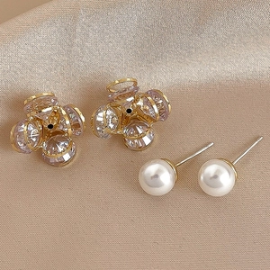 Elegant gold flower ear jackets with white pearls and zircons on champagne satin