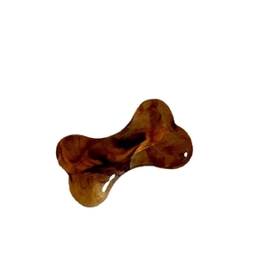 Brown bone-shaped hair clip with marble texture and handmade engraving on white background