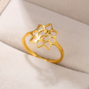 Macro shot of 18k gold plated stainless steel ring with yin yang and starburst design