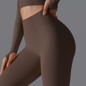 Detail of coffee brown seamless yoga leggings and thumbhole long sleeve crop top fitness set