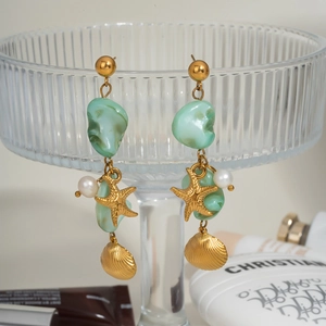Elegant gold starfish and shell dangle earrings with green stones and pearls