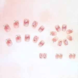 Elegant pink gradient press-on nails with white camellia flowers and gold line accents