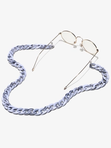 Detailed macro view of marble-textured acrylic eyewear chain in grey-blue with metal clasps