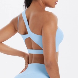 Side-back view of light blue one-shoulder sports bra with crisscross open back design
