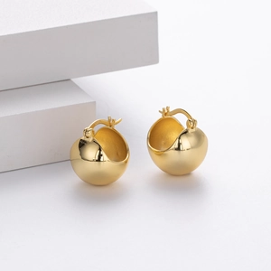 Macro shot of S925 sterling silver stamp on minimalist gold-plated ball hoop earrings