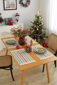Detailed close-up of a woven cotton linen table runner with red and green diamond pattern