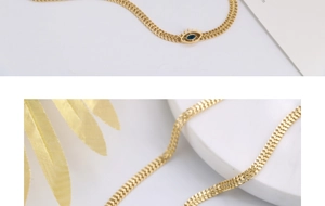 Close-up of golden flat snake chain with a blue evil eye pendant and lash details