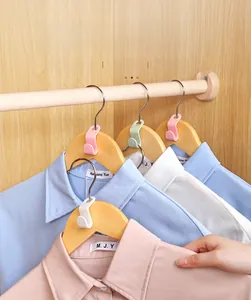 Space-saving plastic hanger connector hooks in multiple colors used in a wooden wardrobe