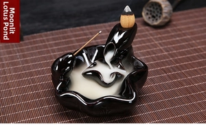 Close-up of ceramic lotus pond backflow incense burner with flowing smoke detail