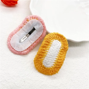 Detailed view of handmade crochet hair clip front and back with silver metal BB clip
