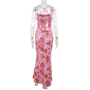 Detail of pink floral dress featuring open back design with adjustable ribbon ties