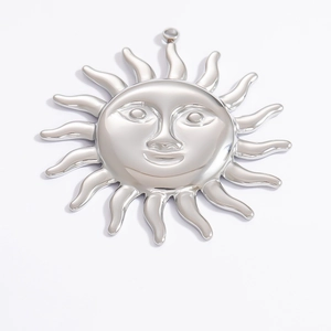 Detailed macro view of silver sun face charm pendant crafted in polished stainless steel