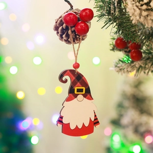 Detail of wooden gnome ornament with pine cone and red berries on a warm Christmas tree