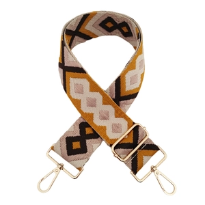 Close-up of geometric diamond jacquard bag strap with gold metal hooks and adjusters