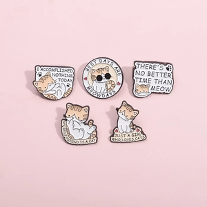 Close-up of five cute enamel cat pins with funny slogans on a pink background