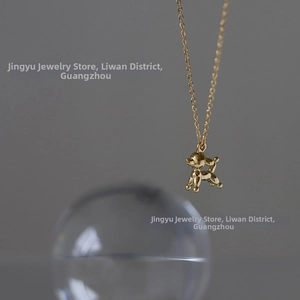 Detailed view of an 18K gold plated balloon dog pendant on a delicate chain necklace