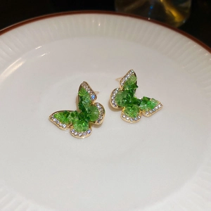 Close-up of 18k gold plated butterfly stud earrings with green crystals and white zircon