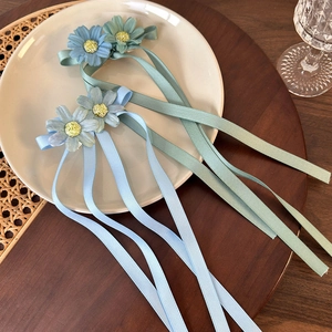 Daisy flower hair clips with long ribbons in light blue and teal for girls