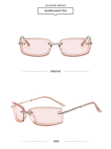 Detail view of rimless rectangular sunglasses with silver metal temples and light tea lenses