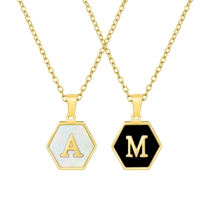 Detail of gold hexagon necklaces with white shell letter A and black letter M pendants