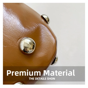 Macro view of brown glossy leather material with silver metal stud details on the bag
