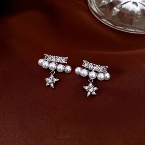 Double-layer pearl and zircon ear cuff with hanging star pendants on brown silk