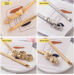 Detail of elastic metal chain belts with floral and heart buckles in gold and silver