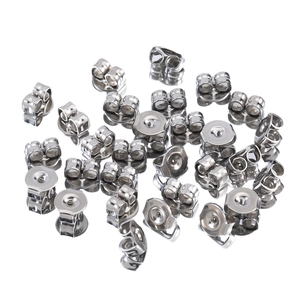 Bulk silver stainless steel butterfly earring backs on a clean white mirrored surface