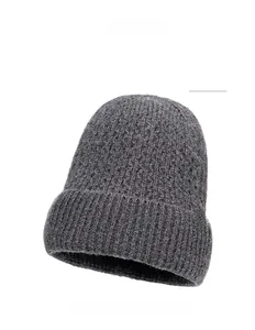 Detail view of dark gray knit beanie featuring a thick ribbed texture and brown leather label