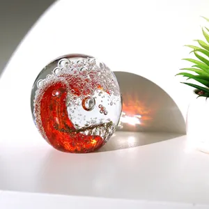 Artistic crystal ocean wave ball ornament with a red spiral core for modern home decor