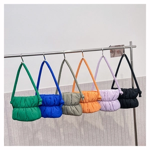 Hanging display of colorful puffy nylon tote bags with quilted pleats and soft texture