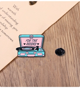 Detail shot of vintage teal record player enamel pin with FOR THE RECORD text