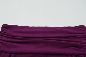 Detailed view of dark purple knitted dress featuring horizontal pleated ruched texture