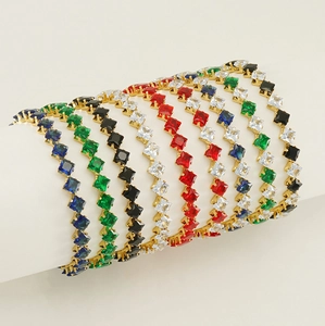 Detail of tennis bracelets with square gemstones in blue, green, black, white, and red