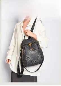 Detail of black New Chinese style backpack with golden wave embossed pattern and metal logo
