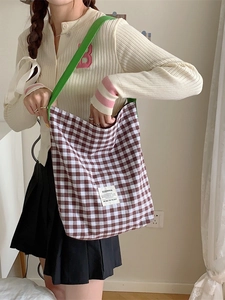 Canvas checkered tote bag with green shoulder strap and minimalist gingham design