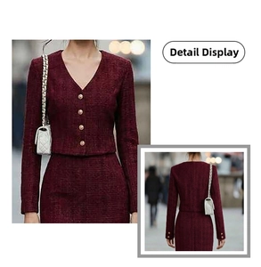 Detail of wine red tweed texture and embossed metal buttons on a V-neck elegant suit