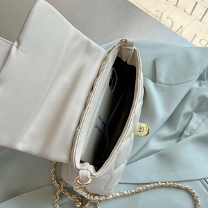 Detailed view of cream quilted chain bag interior showing space for a smartphone