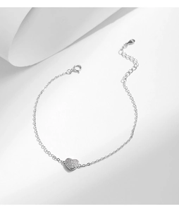 Detailed macro view of S925 sterling silver heart pendant with shimmering crystals