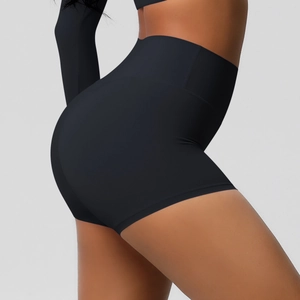Detail view of high waisted black compression shorts showing elastic tummy control fit
