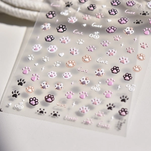 Close-up of 3D embossed cat paw nail stickers with cute heart and star patterns