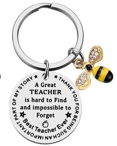 Macro shot of silver teacher appreciation keychain with gold bee and engraved thank you message