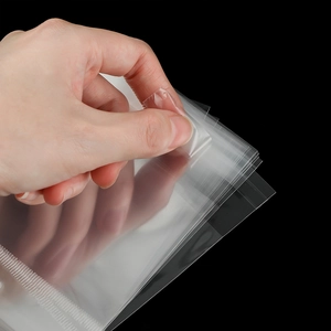 Close-up of transparent OPP self-adhesive bag showing clear film and sealing strip