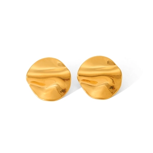 Macro detail of golden irregular wave earrings showing smooth 18K gold-plated texture