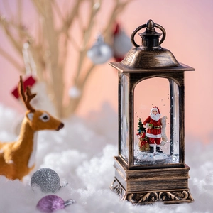 Bronze Christmas lantern snow globe with Santa Claus scene and warm festive lighting