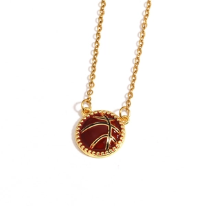 Detail of a golden basketball pendant necklace featuring red enamel and beaded edges